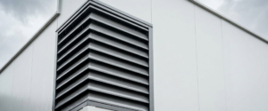 Angled Colorbond louvres Sydney fitted to a commercial plant room wall for weatherproof airflow